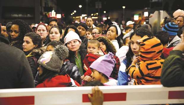 Migrants block the Paso del Norte border crossing bridge in Ciudad Juarez, Mexico, on Friday night.
