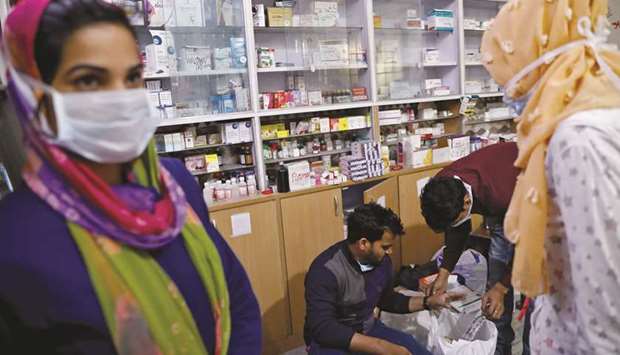 Paramedics take medical supplies from a store at Al-Hind hospital, where victims are treated and many have taken shelter after they fled their homes following clashes between people demonstrating for and against a new citizenship law in a riot affected area in New Delhi.