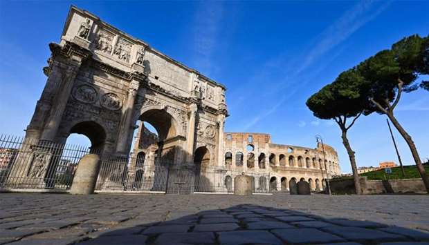 A general view shows a deserted area by the Arch of Constantine (L) and a closed Colosseum monument in Rome
