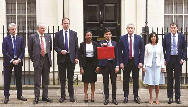 Chancellor of the Exchequer Rishi Sunak poses with his Treasury team outside his office in Downing Street in London yesterday.