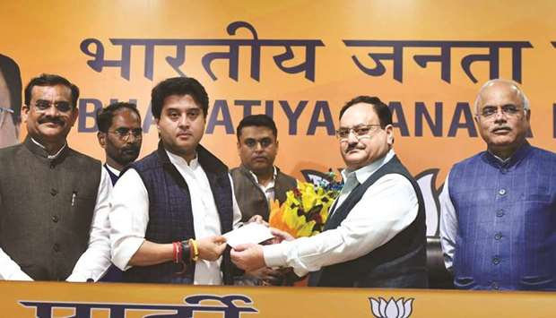 BJP president J P Nadda presents the membership card to Jyotiraditya Scindia in New Delhi yesterday.