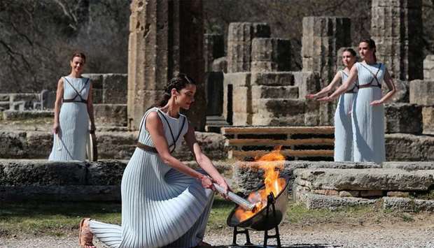 Greek actress Xanthi Georgiou, playing the role of High Priestess, lights the flame during the Olympic flame lighting ceremony for the Tokyo 2020 Summer Olympics