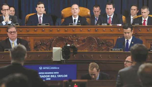 Chairman Adam Schiff (centre), Democrat of California, gives an opening statement during the first public hearings held by the House Permanent Select Committee on Intelligence as part of the impeachment inquiry into US President Donald Trump, with witnesses Ukrainian ambassador William Taylor and Deputy Assistant Secretary George Kent testifying, on Capitol Hill in Washington, DC, US, November 13, 2019.