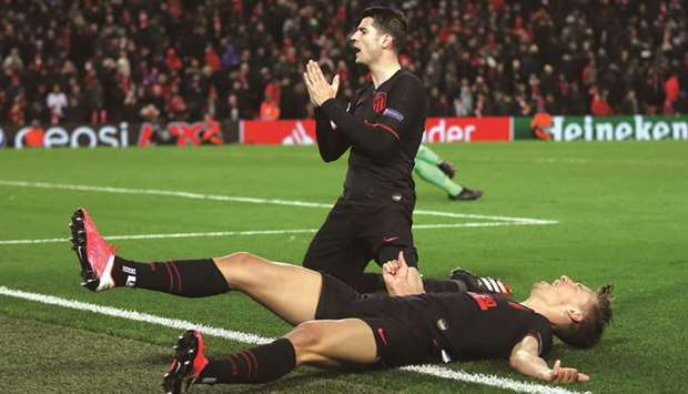 Atletico Madridu2019s Alvaro Morata (left) celebrates scoring their third goal with Marcos Llorente during the UEFA Champions League match against Liverpool at Anfield in Liverpool, United Kingdom, on Wednesday. (Reuters)