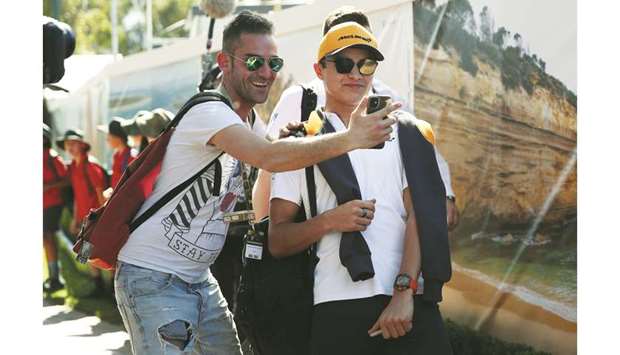 A fan clicks a selfie with McLarenu2019s Lando Norris in Melbourne yesterday.