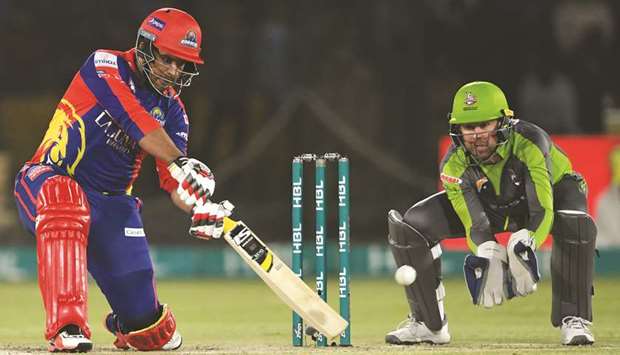 Karachi Kingsu2019s Sharjeel Khan (left) plays a shot as Lahore Qalandarsu2019s wicketkeeper Ben Dunk looks on during their PSL match at the National Cricket Stadium in Karachi yesterday. (AFP)