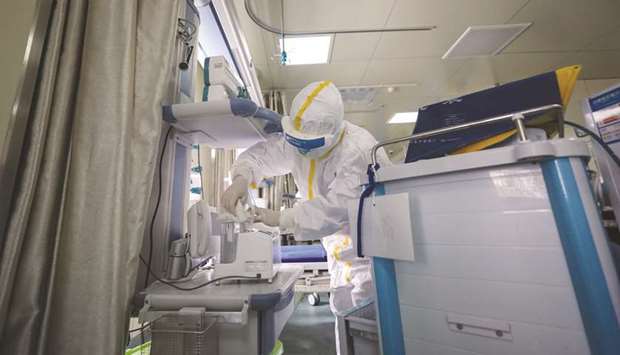 A medical staff member disinfects equipment at a ward used to be an isolation ward for patients infected by the coronavirus at a hospital in Wuhan.