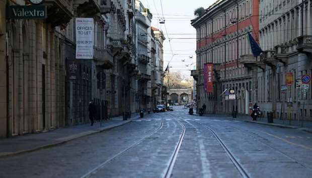 The deserted Via Manzoni street is seen on the fourth day of an unprecedented lockdown across of all Italy imposed to slow the outbreak of coronavirus, in Milan, Italy