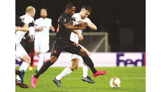 Manchester Unitedu2019s Odion Ighalo (left) and LASK Linzu2019s James Holland battle for the ball during the Europa League last 16 first leg at the Linzer Stadion in Linz, Austria, on Thursday night. (AFP)