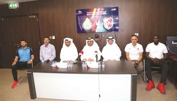 Al Gharafa coach Kosay Hatem (second from left) and Al Shamal coach Hassan Hached (second from right) pose with the officials and players during a press conference ahead of todayu2019s Qatar Menu2019s Basketball League final. PICTURES: Anas Khalid