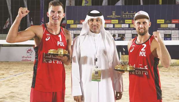 Qatar Volleyball Association president Ali Ghanim al-Kuwari (centre) poses with winners of the FIVB -Star Katara Cup Beach Volleyball tournament, Polandu2019s Grzegorz Fijalek (left) and Michal Bryl yesterday. PICTURES: Jayaram