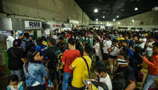 Passengers line up inside the Araneta Center Bus Terminal in Cubao for tickets in Manila yesterday following President Rodrigo Duterte's announcement of a local travel ban in the Philippine capital.