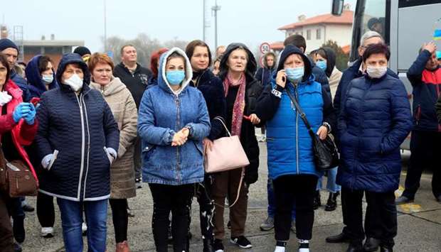 Ukrainian workers from Italy wait to continue their journey to Kiev, as they are not allowed by the Slovenian border authorities due to coronavirus disease (COVID-19) fears, at the border crossing with Italy in Fernetici, Slovenia
