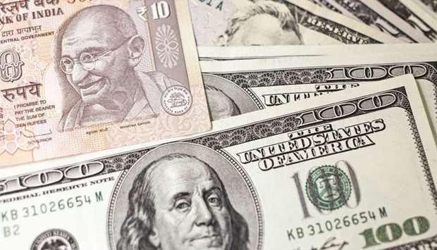 An Indian ten rupee banknote and US one-hundred dollar banknotes are arranged for a photograph in Mumbai. Indiau2019s central bank pledged to use its record $481bn foreign-currency arsenal to stem a market rout thatu2019s threatening growth in an already-slowing economy.
