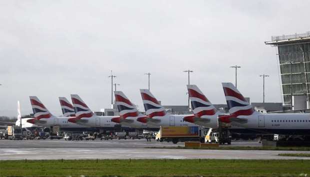 The tail fins of parked British Airways planes are seen near Terminal 5 at Heathrow Airport in London