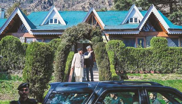 Farooq Abdullah gestures as he walks along with senior Congress leader Ghulam Nabi Azad outside Abdullahu2019s residence in Srinagar yesterday.