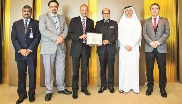 Doha Bank Group CEO Dr R Seetharaman and other top officials with the award from u2018Middle East Digital Excellence Architecture Awards 2019u2019.