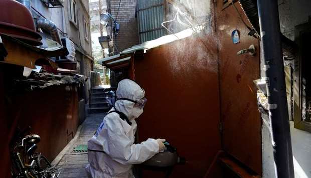An employee from a disinfection service company sanitizes a shack at a shanty area, following the outbreak of the coronavirus disease (COVID-19), in Seoul, South Korea