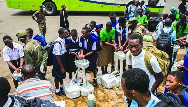 Secondary school students wash their hands at a a temporary hand washing point before they return home on Monday as Rwandan Government decided to send back all students of boarding schools after the first case of Covid-19 was found on March 13, in Kigali.