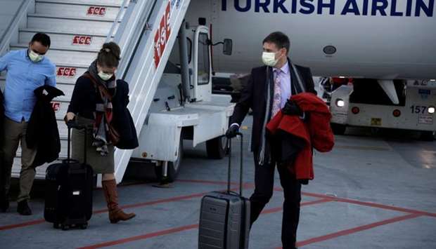 A passenger wears a protective face mask in light of the coronavirus, upon arrival at Istanbul Airport, Turkey