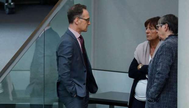 German Foreign Minister Heiko Maas (L) talks with former Environment Minister Barbara Hendricks (R) and former Health Minister Ulla Schmidt (C) during a session of the Bundestag (lower house of parliament) in Berlin on March 12