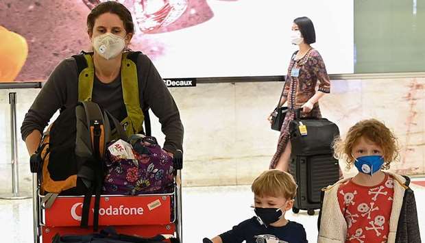 Passengers arrive at Sydneyu2019s international airport yesterday. Australia announced Sunday that anyone arriving into the country will face mandatory 14-day self-isolation, in a bid to slow the spread of the coronavirus.