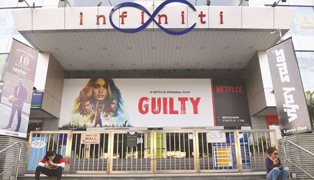 People sit outside the Infinity mall after its closure amid concerns over the spread of the Covid-19, in Mumbai yesterday.