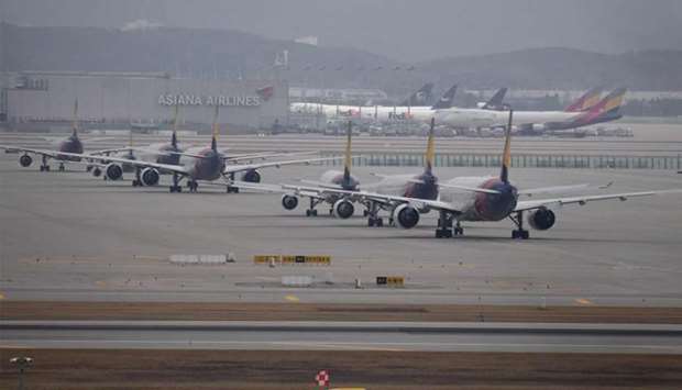 Commercial aircraft are seen parked on the tarmac at Incheon international airport, west of Seoul