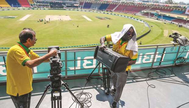 Television crew members pack up their equipment at the Gaddafi Cricket Stadium in Lahore yesterday. (AFP)