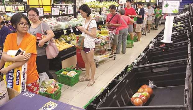 People queuing for groceries at a supermarket in Singapore, amid concerns over the spread of the novel coronavirus.