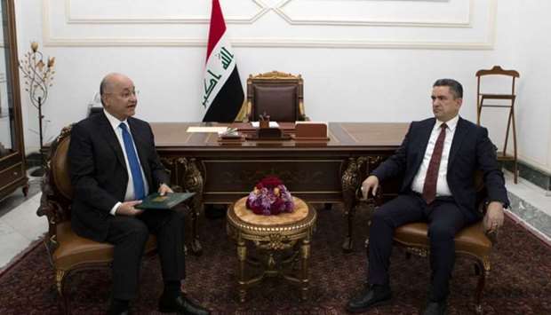 A handout picture released by the media office of the Iraqi Presidency yesterday shows President Barham Saleh meeting with prime minister-designate Adnan Zurfi (right) in Baghdad.