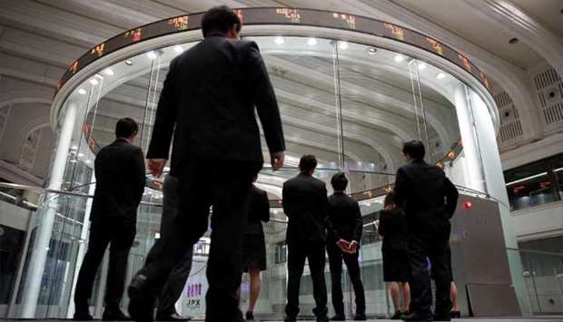 Visitors watch stock prices at the Tokyo Stock Exchange. The Nikkei 225 closed down 1.7% to 16,726.55 points yesterday.