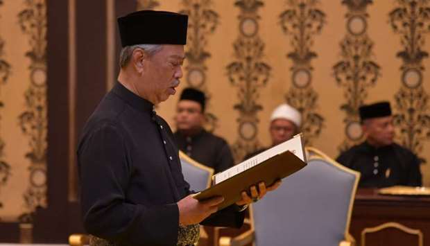Malaysia's incoming Prime Minister Muhyiddin Yassin reading the oath during his swearing-in ceremony as the country's new leader at the National Palace in Kuala Lumpur.  AFP/Malaysia's Department of Information/Maszuandi Adnan