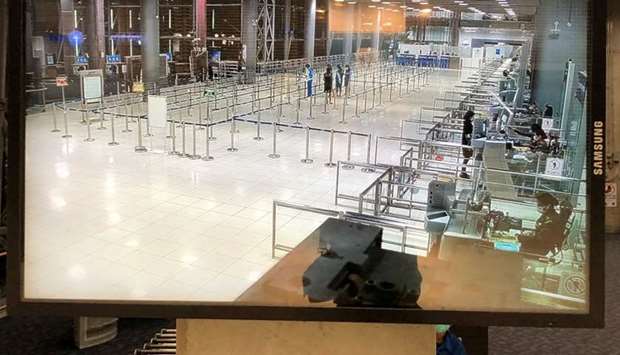 A screen shows the arrival hall at the immigration area at 8:20pm Saturday night at Suvarnabhumi international airport in Bangkok, Thailand
