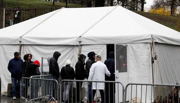 People queue to enter a tent erected to test for the coronavirus disease (Covid-19) at the Brooklyn Hospital Centre in Brooklyn.