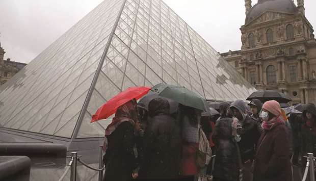 People line up at the Louvre Museum after the site was closed during a staff meeting about the coronavirus outbreak.