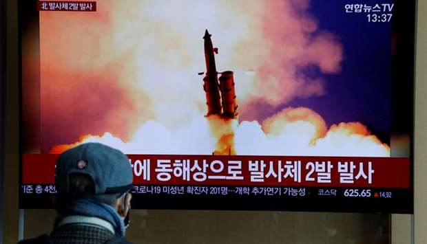 A man watches a TV showing a file picture for a news report on North Korea firing two unidentified projectiles, in Seoul, South Korea