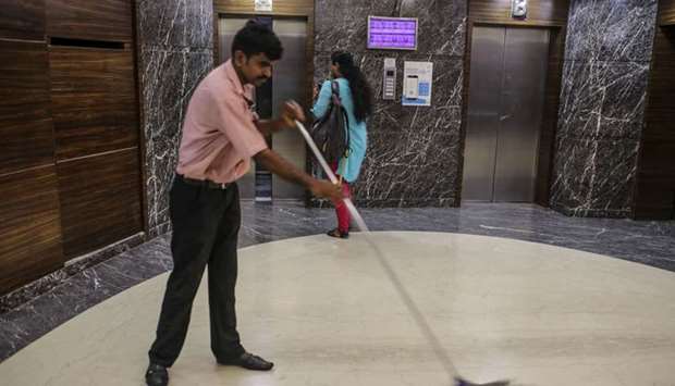 An employee sweeps the floor inside the Bombay Stock Exchange (BSE) building in Mumbai (file). The S&P BSE Sensex Index marked its biggest weekly decline since October 2008, after entering into a bear market in the previous week. The gauge surged 5.8%, the most in a single session since May 2009 yesterday.