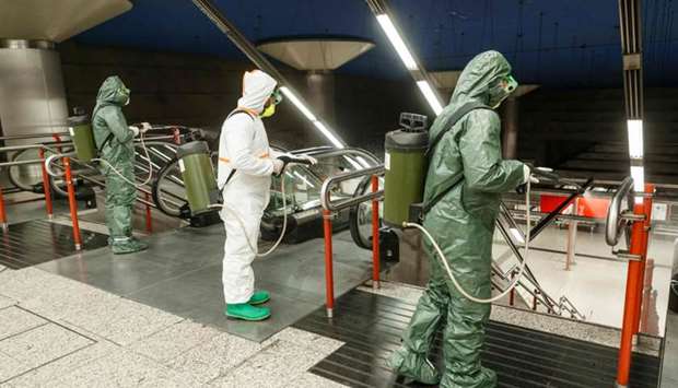 Members of the NBQ company (nuclear, bacteriological and chemical) of the 'Guadarrama XII' Brigade carry out a general disinfection at the Nuevos Ministerios Metro Station in Madrid