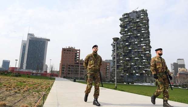 Italian army soldiers patrol streets after being deployed to the region of Lombardy to enforce the lockdown against the spread of coronavirus disease (COVID-19) in Milan, Italy