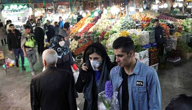 An Iranian woman wears a protective face mask, amid fear of coronavirus disease (Covid-19), as she shops at Tajrish Bazar, ahead of the Iranian New Year Nowruz, on Friday, in Tehran.