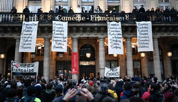 Actors with costumes and employees of the Comedie Francaise perform on the balconies of the Comedie Francaise to protest against the pension reforms