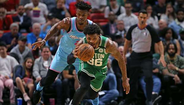 File photo of Boston Celticsu2019 Marcus Smart (36) steals the ball from Miami Heatu2019s Jimmy Butler in the first quarter at the AmericanAirlines Arena in Miami on January 28, 2020. (TNS)