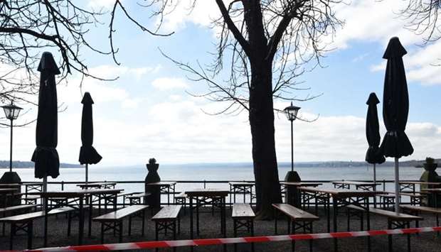 A barrier tape is stretched in front of a closed beer garden in Stegen near the lake Ammersee, southern Germany