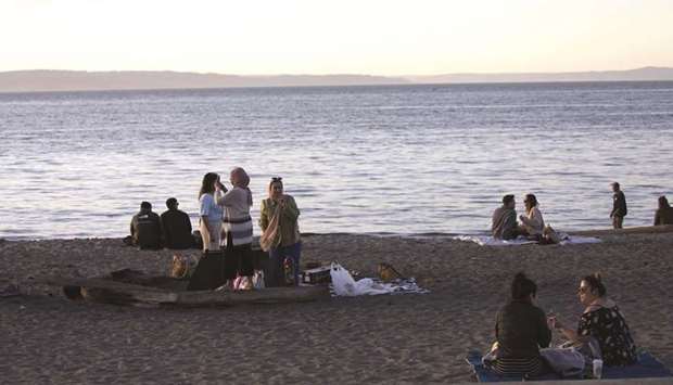 People exercise social distancing at Alki Beach Park on Friday in Seattle, Washington. Some US physicians have been prescribing hydroxychloroquine for patients, friends and family as a Covid-19 treatment or as a precaution. Doctors have wide discretion to prescribe medications for unapproved uses.