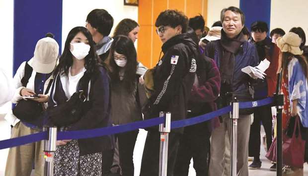 People wear protective face masks at El Alto-La Paz international airport in Bolivia.