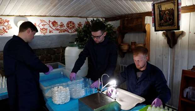 A clergyman of the Orthodox Church of Ukraine and students of the theological seminary produce hand sanitizer to donate it to the elderly and people in need to prevent the spread of coronavirus disease (COVID-19) at the Vydubychi Monastery in Kiev