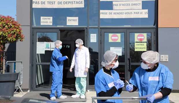 Medical staff wearing protective gears stand outside the new Covid-19 diagnose center in a gymnasium in Taverny, yesterday on the seventh day of a lockdown aimed at curbing the spread of the Covid-19 (novel coronavirus) in France