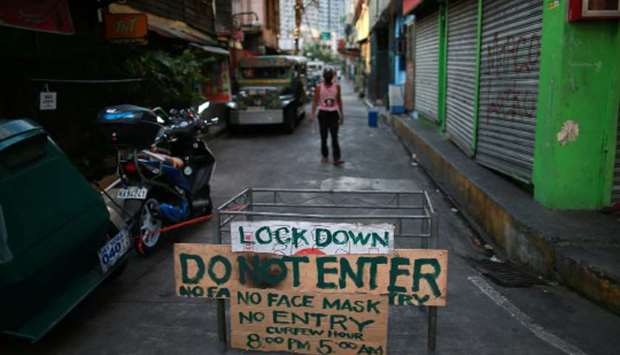 A makeshift barricade blocks a street from outsiders to protect a neighbourhood from the spread of coronavirus disease (Covid-19) in Manila, yesterday.
