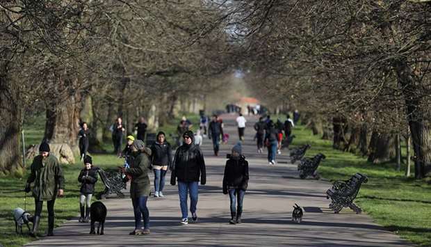 People walk through Greenwich Park yesterday, as the spread of the coronavirus disease continues, in London.